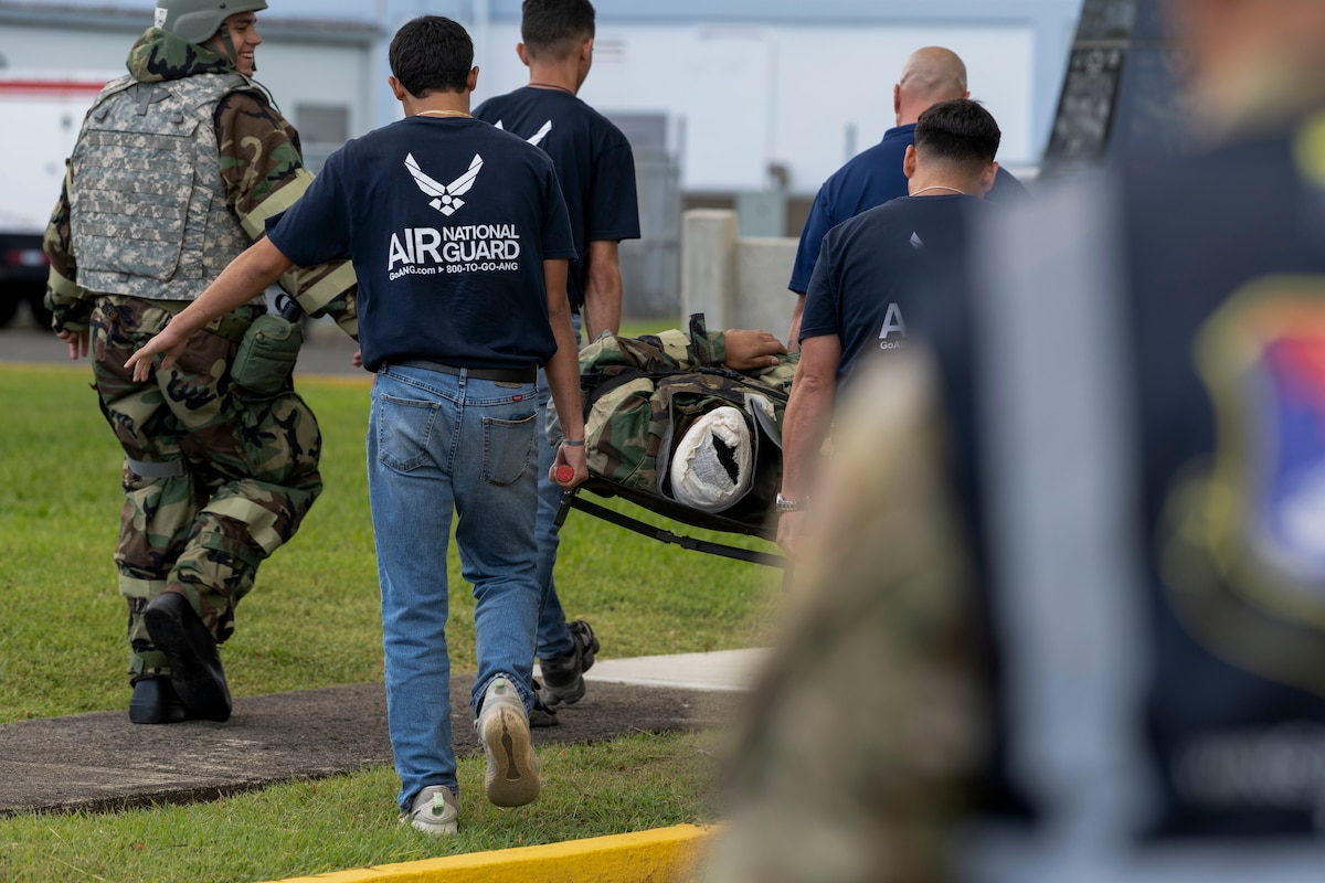 U.S. Airmen assigned to the 156th Civil Engineer Squadron, Puerto Rico Air National Guard, carry a simulated casualty during the Prime BEEF day exercise at Muñiz Air National Guard Base, Carolina, Puerto Rico, June 8, 2025. The exercise tested the 156th CES operational readiness and response to several structural incidents due to a simulated enemy aerial attack. (U.S. Air National Guard photo by Senior Airman Victoria A. Jewett)