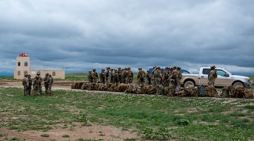  Security forces members line up their bags and begin setting up equipment and stations