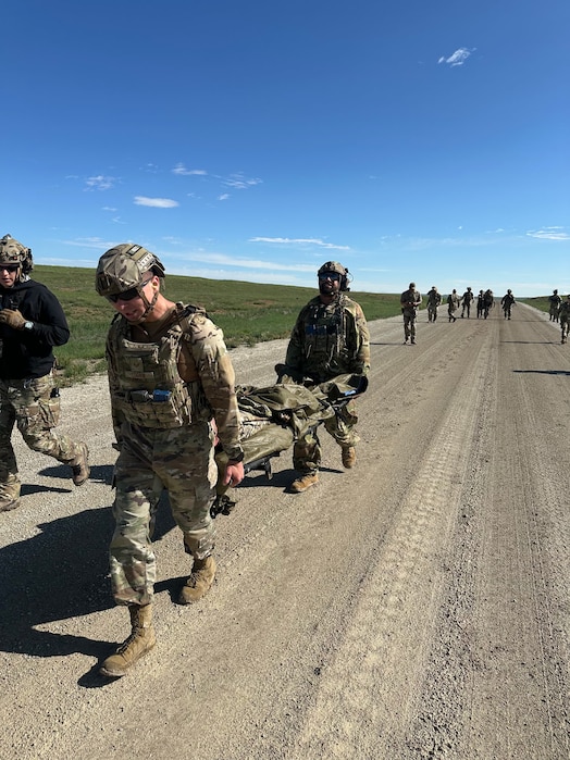 Security forces members carry a fellow teammate on a stretcher during an exercise.