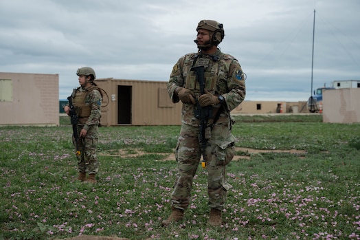  Two security forces members stand guard during an exercise.