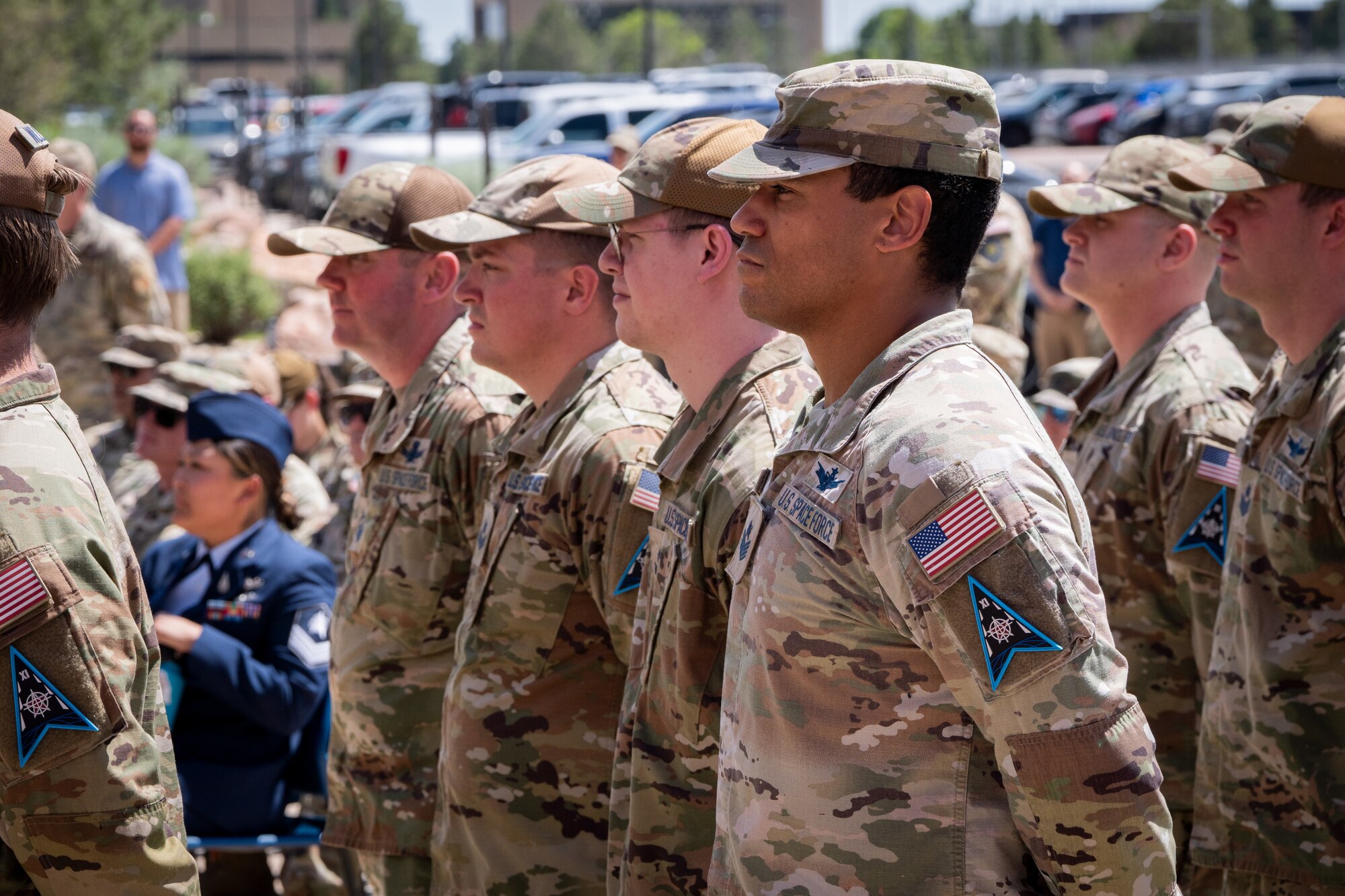 Change of command ceremony with flags and uniformed personnel.