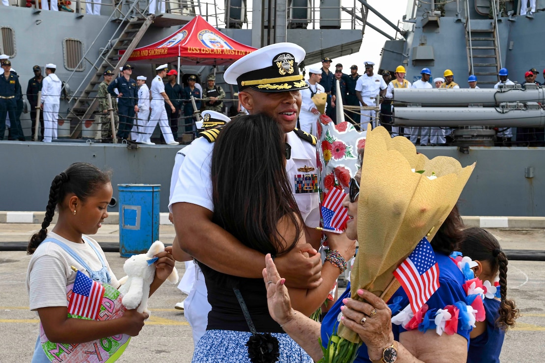 A Sailor embraces family.