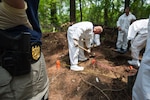 NCIS personnel conduct a forensic dig.