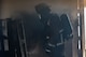 Firefighter walking in structure with surrounding smoke