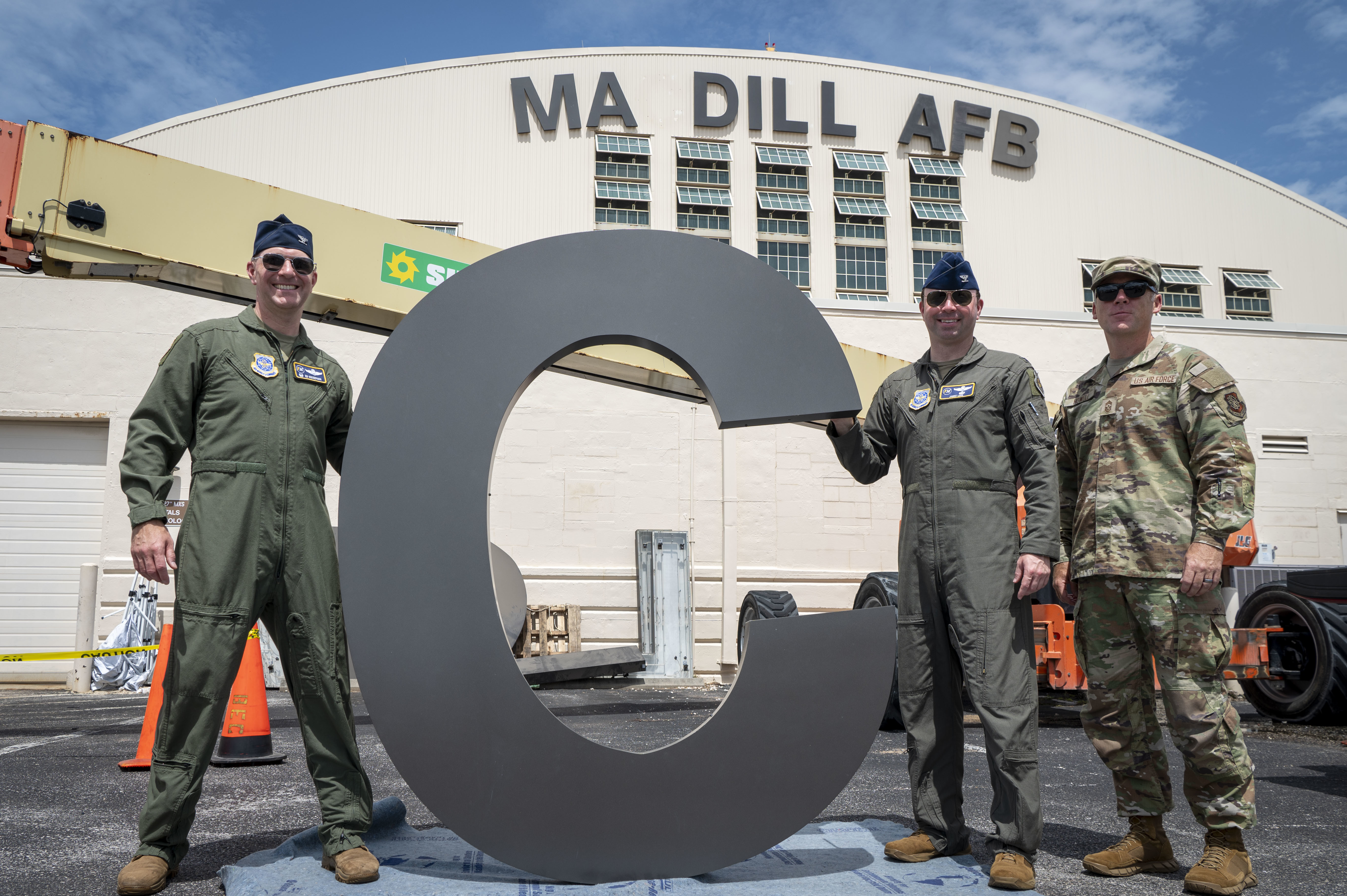 From left, U.S. Air Force Col. Edward Szczepanik, 6th Air Refueling Wing commander, Col. James Long, 6th ARW deputy commander, and Chief Master Sgt. Raun Howell, 6th ARW command chief, hold up the letter “C” before it is installed on Hangar 3 at MacDill Air Force Base, Florida, June 6, 2025. The previous letter was blown off the hangar during Hurricane Helene, a Category 4 hurricane that struck the region in September 2024. Since then, extensive repairs have been completed, with the recent restoration of the iconic MacDill AFB sign symbolizing the base’s recovery from the hurricanes. (U.S. Air Force photo by Airman 1st Class Alicia Campbell)
