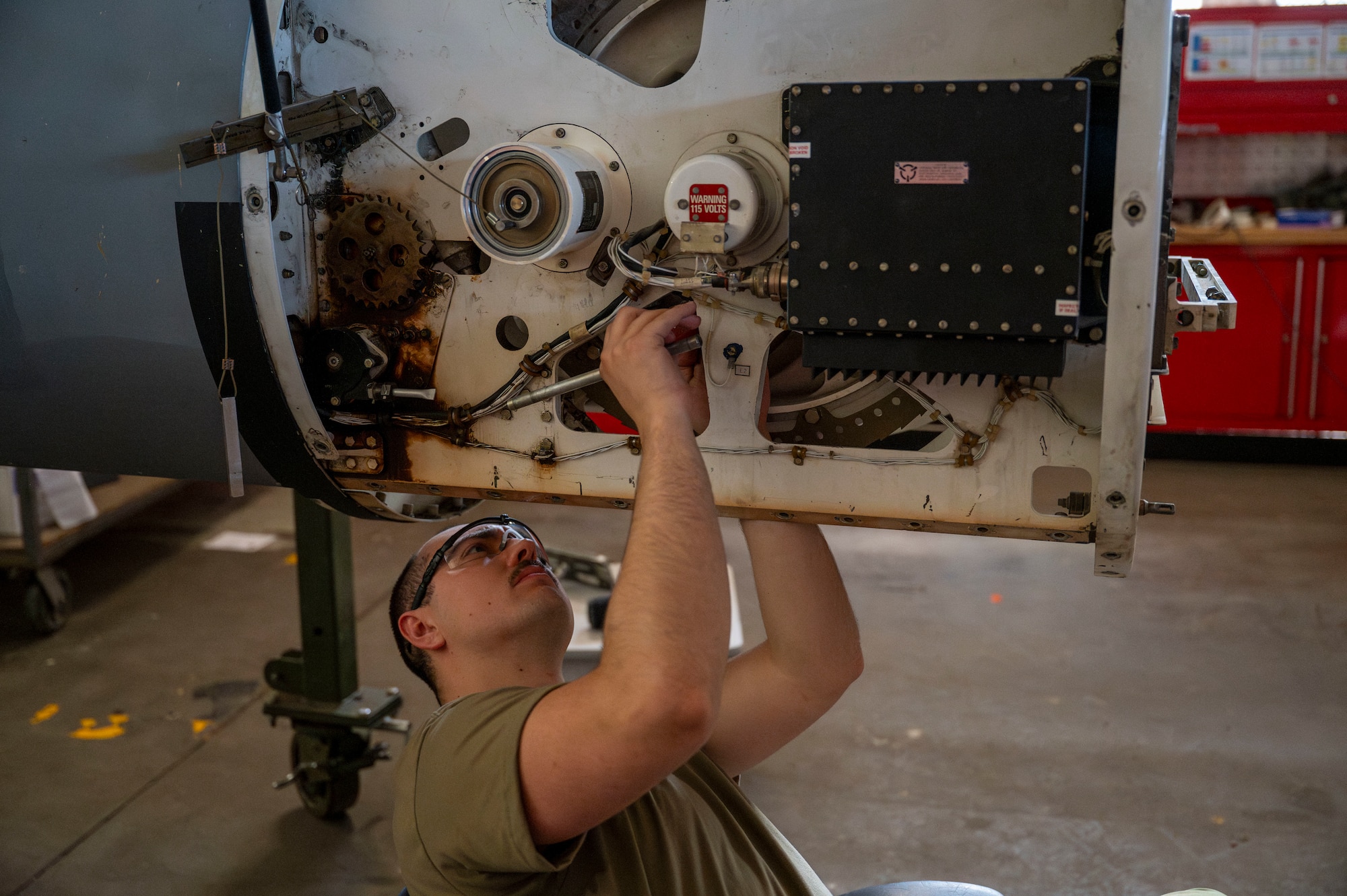 Airman replaces a primary chain on a Multi-Point Refueling System pod.