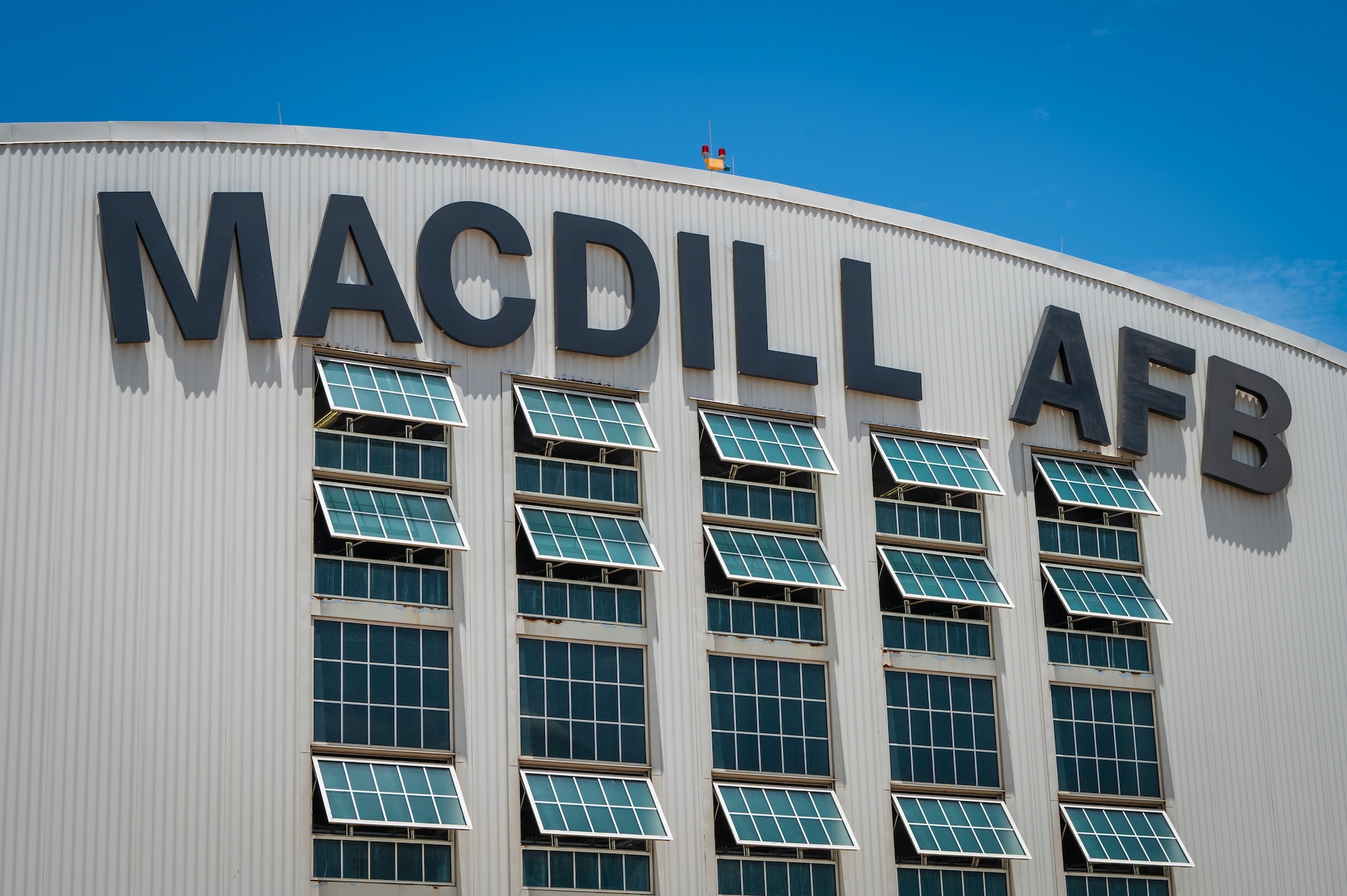 he front of Hangar 3 is shown at MacDill Air Force Base, Florida, June 6, 2025. The letter “C” was blown off the hangar during Hurricane Helene, a Category 4 hurricane that hit the region in September 2024. Since then, extensive repairs have been completed, with the recent restoration of the iconic MacDill AFB sign symbolizing the base’s recovery from the hurricanes. (U.S. Air Force photo by Airman 1st Class Alicia Campbell)