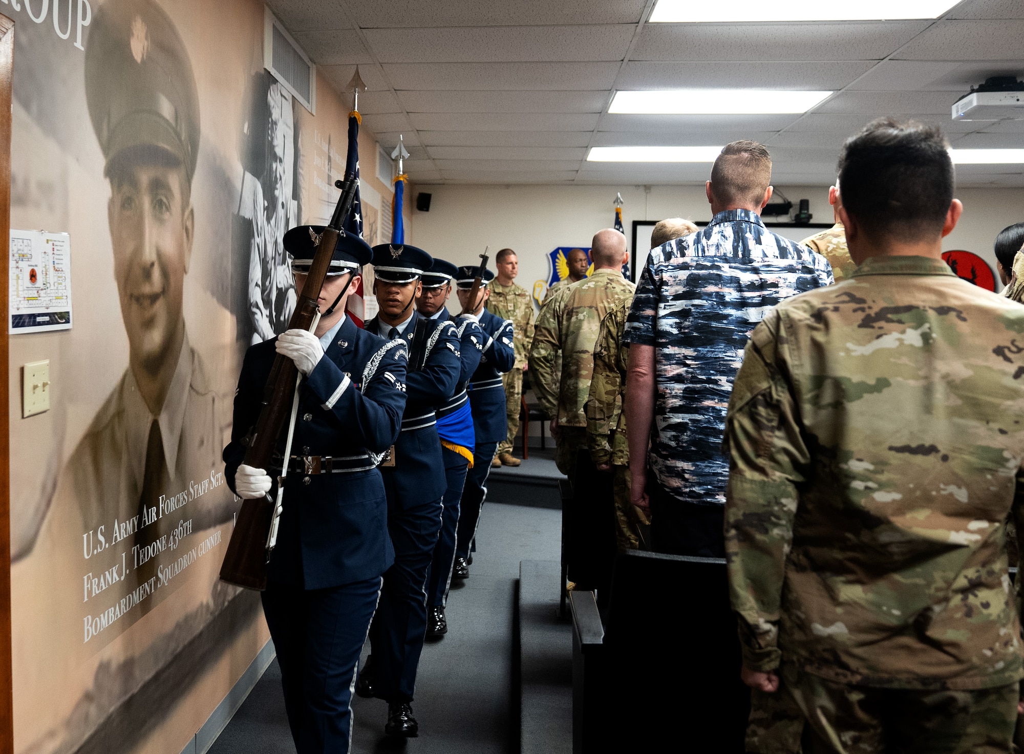 A 7th Bomb Wing honor guard color guard detail exits the Apocalypse Hall auditorium at the 436th Training Squadron, June 2, 2025, at Dyess Air Force Base, Texas. he 436th TRS auditorium was named "Apocalypse Hall" after U.S. Army Air Corps members 2nd Lt. John E. McLauchlen, Tech Sgt. Harold L. Seifried and Staff Sgt. Frank J. Tedone who were crewmembers at the start of World War II attached to the 436th Bombardment Squadron.  All three men lost their lives when the B-24J Liberator “Apocalypse” was shot down in the Southwest Pacific. (U.S. Air Force photo by Master Sgt. Eboni Reams)