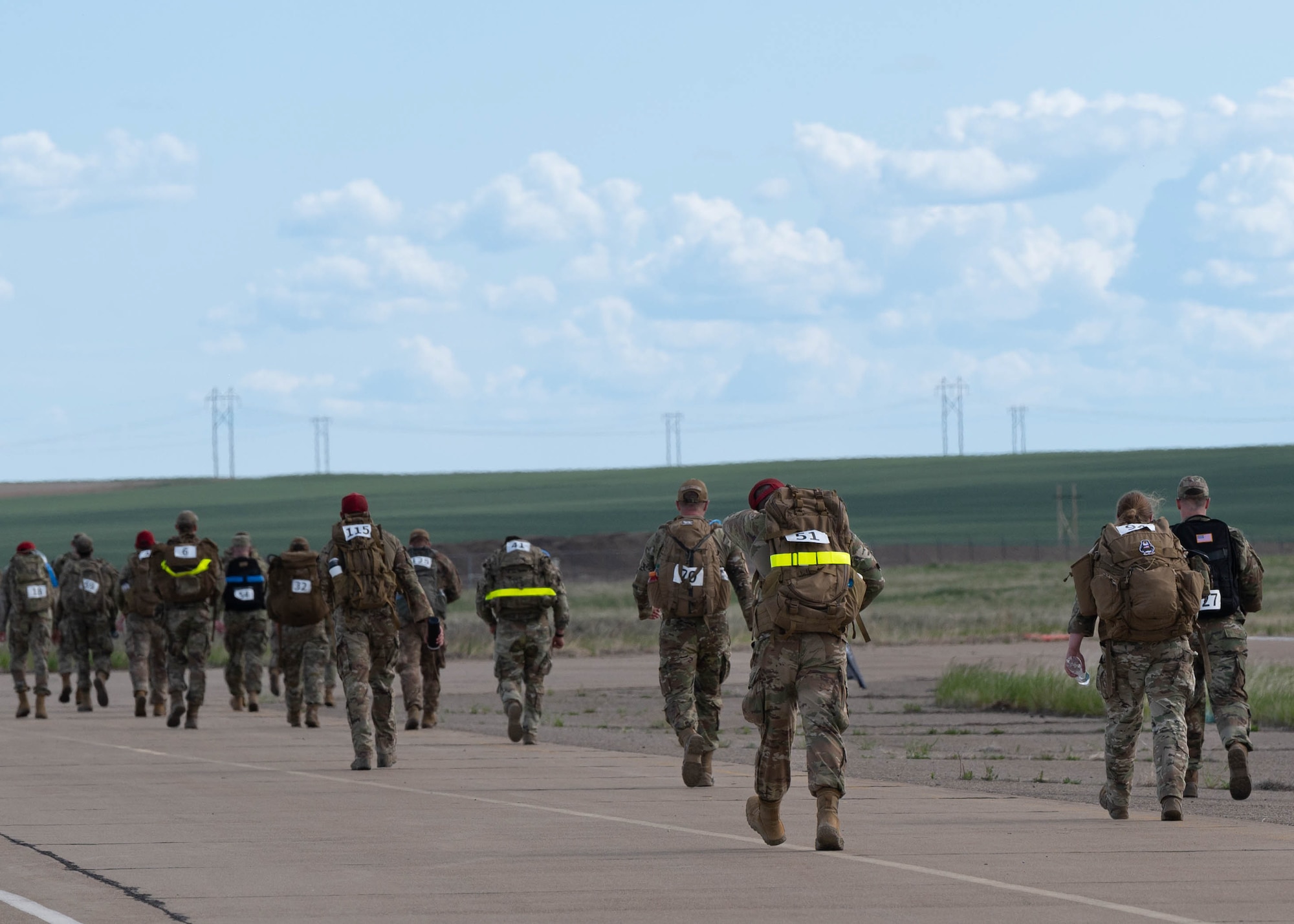 Group of Airmen running with ruck sacks