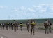 Group of Airmen running with ruck sacks