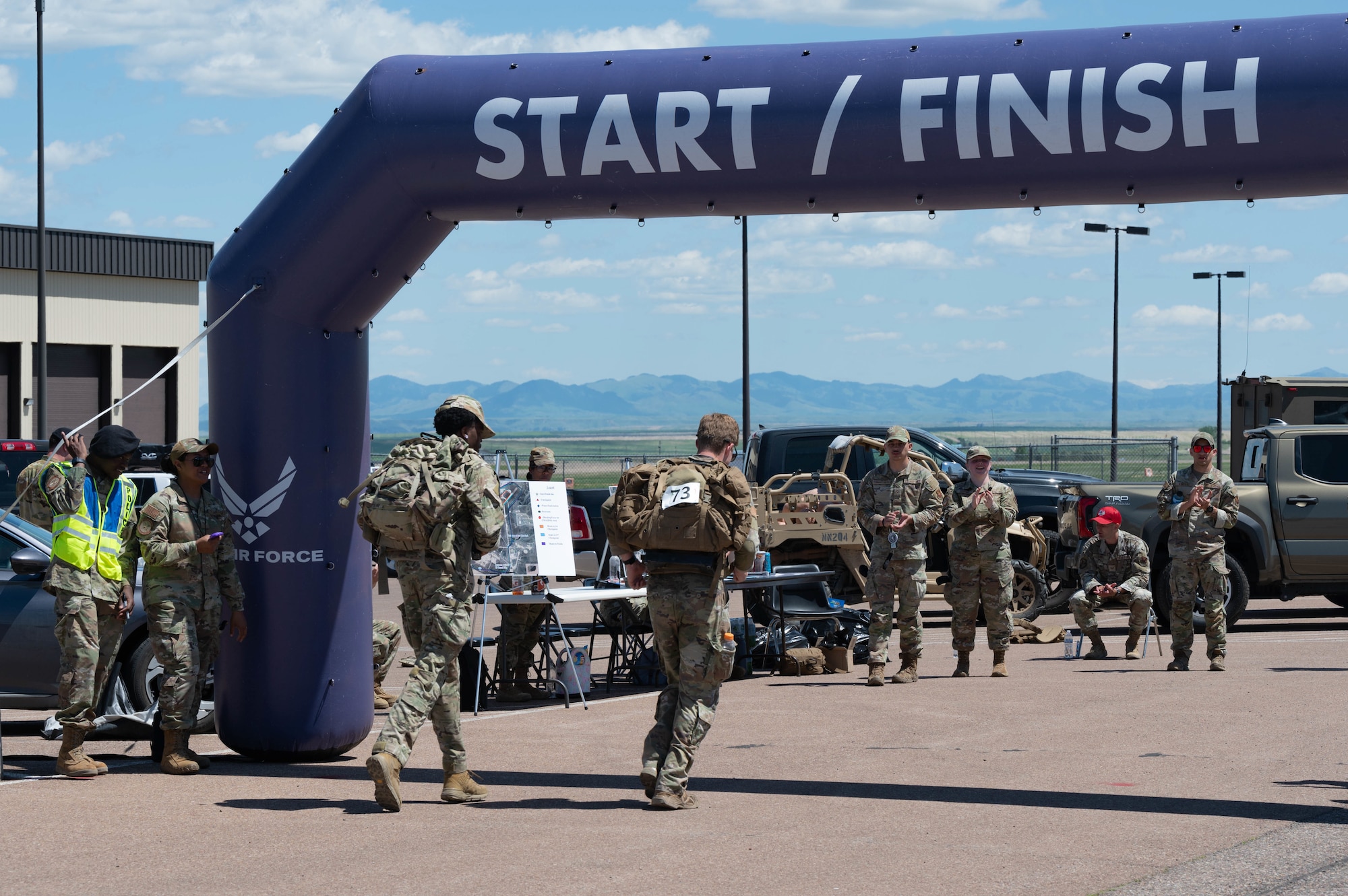 Two Airmen crossing finish line.