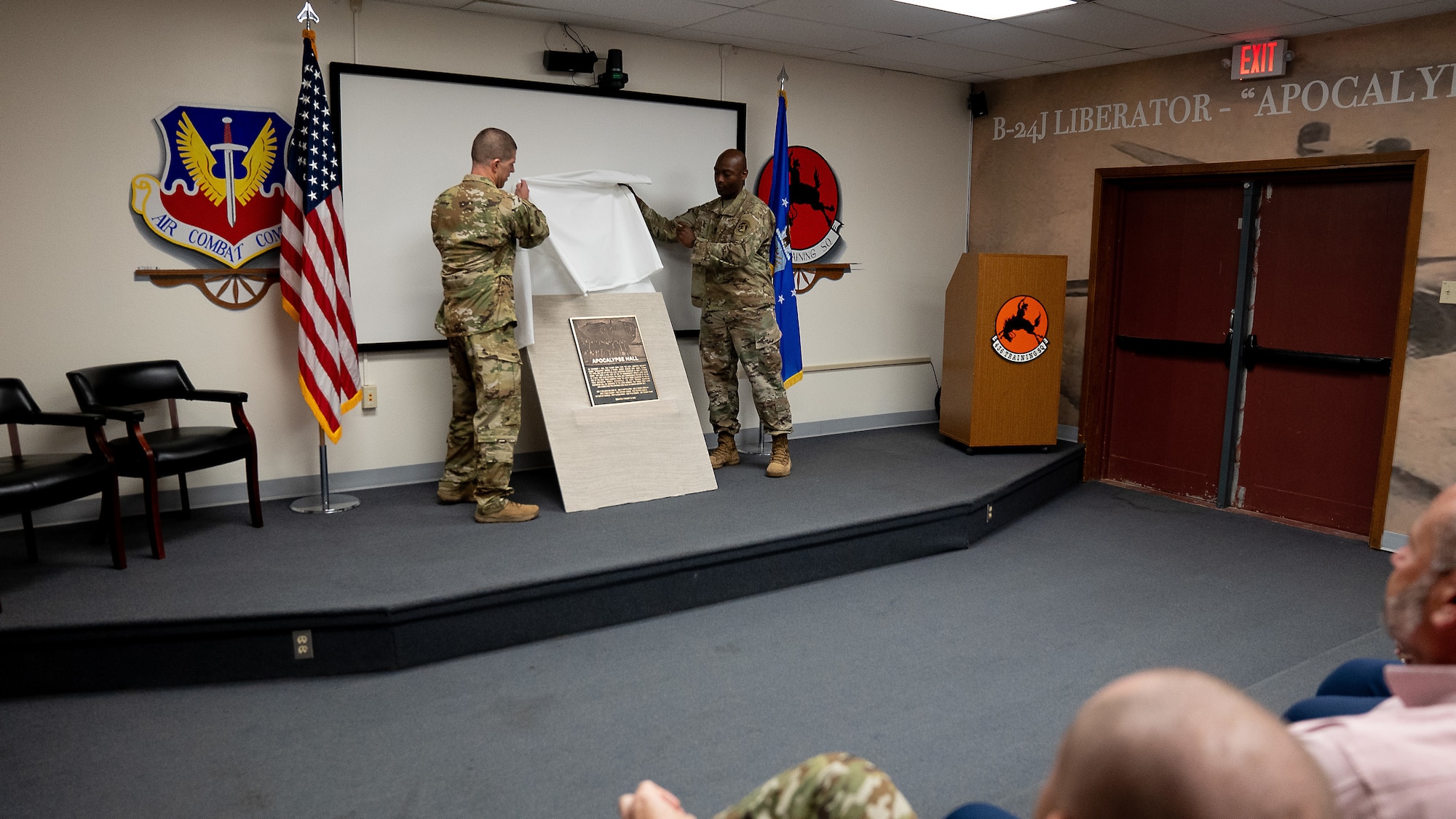 From left, U.S. Air Force Col. Seth Spaniel, 7th Bomb Wing commander, and U.S. Air Force Lt. Col. Glen D. Jasper, Jr., 436th Training Squadron commander unveil the ‘Apocalypse Hall’ plaque during an auditorium dedication ceremony at the 436th Training Squadron, June 2, 2025, at Dyess Air Force Base, Texas. he 436th TRS auditorium was named "Apocalypse Hall" after U.S. Army Air Corps members 2nd Lt. John E. McLauchlen, Tech Sgt. Harold L. Seifried and Staff Sgt. Frank J. Tedone who were crewmembers at the start of World War II attached to the 436th Bombardment Squadron.  All three men lost their lives when the B-24J Liberator “Apocalypse” was shot down in the Southwest Pacific. (U.S. Air Force photo by Master Sgt. Eboni Reams)