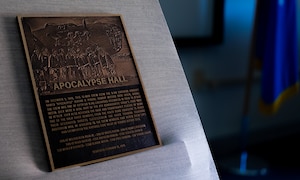 An unveiled plaque rests on the stage of the newly dedicated Apocalypse Hall at the 436th Training Squadron, June 2, 2025, at Dyess Air Force Base, Texas. he 436th TRS auditorium was named "Apocalypse Hall" after U.S. Army Air Corps members 2nd Lt. John E. McLauchlen, Tech Sgt. Harold L. Seifried and Staff Sgt. Frank J. Tedone who were crewmembers at the start of World War II attached to the 436th Bombardment Squadron.  All three men lost their lives when the B-24J Liberator “Apocalypse” was shot down in the Southwest Pacific. (U.S. Air Force photo by Master Sgt. Eboni Reams)