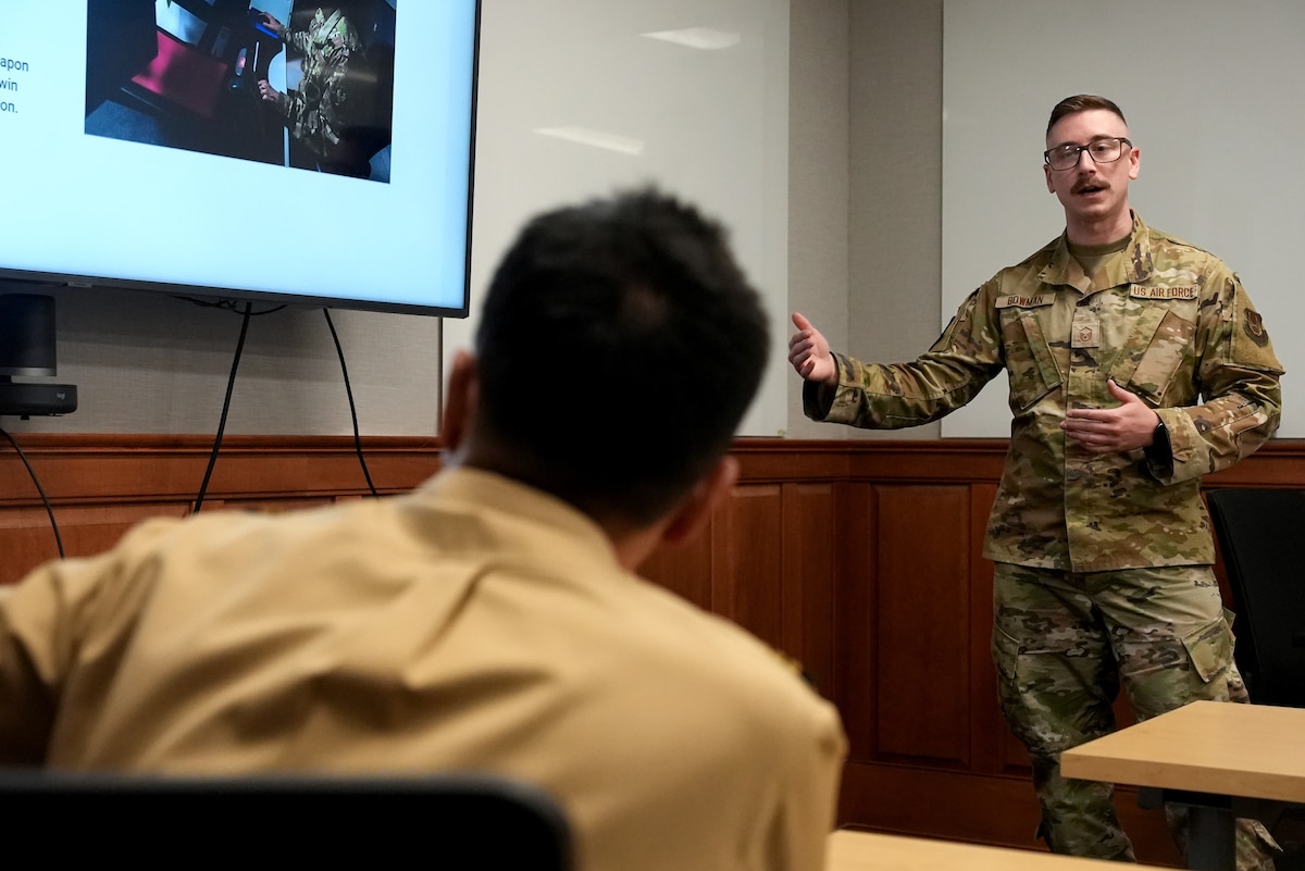 HANSCOM AIR FORCE BASE, Mass., (June 3, 2025) – Master Sgt. Cory Bowman showcases Kessel Run’s capabilities for Japan Maritime Self Defense Force Capt. Daigo Tsubokura, here, June 3, 2025. Delegates from the Japanese Joint Staff met with Airmen to learn more about the Department of the Air Force’s Program Executive Office for Command, Control, Communications and Battle Management’s DAF BATTLE NETWORK. Bowman is Kessel Run’s senior enlisted leader. (Official Air Force Photo by Richard Blumenstein)
