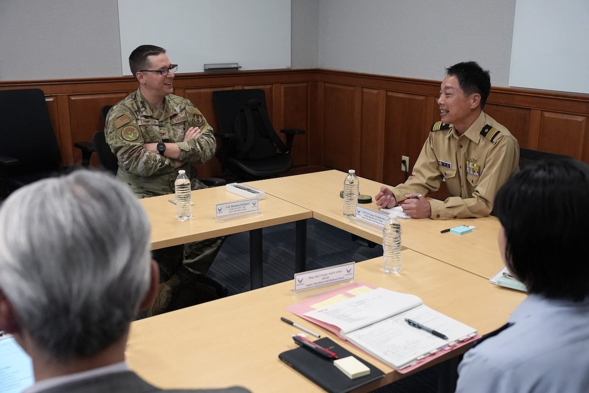HANSCOM AIR FORCE BASE, Mass., (June 3, 2025) – Col. Ted Erickson, left, discusses the DAF BATTLE NETWORK with Japan Maritime Self Defense Force Capt. Daigo Tsubokura, and guests, here, June 3, 2025. Delegates from the Japanese Joint Staff met with Airmen to learn more about the Department of the Air Force’s Program Executive Office for Command, Control, Communications and Battle Management’s DAF BATTLE NETWORK. Erickson is C3BM’s Air Mission Integration Team lead. (Official Air Force Photo by Richard Blumenstein)