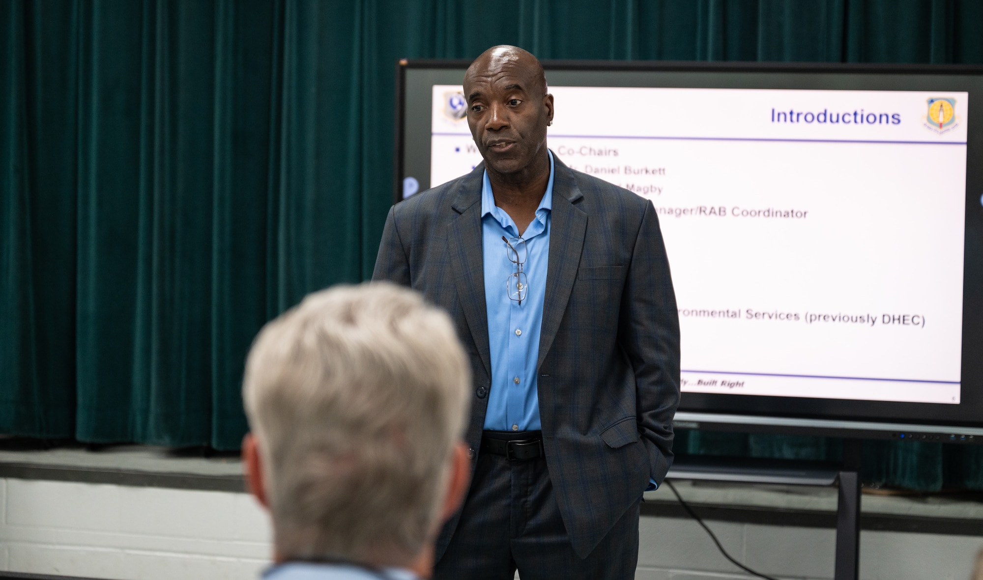 A man stands and speaks to a crowd.