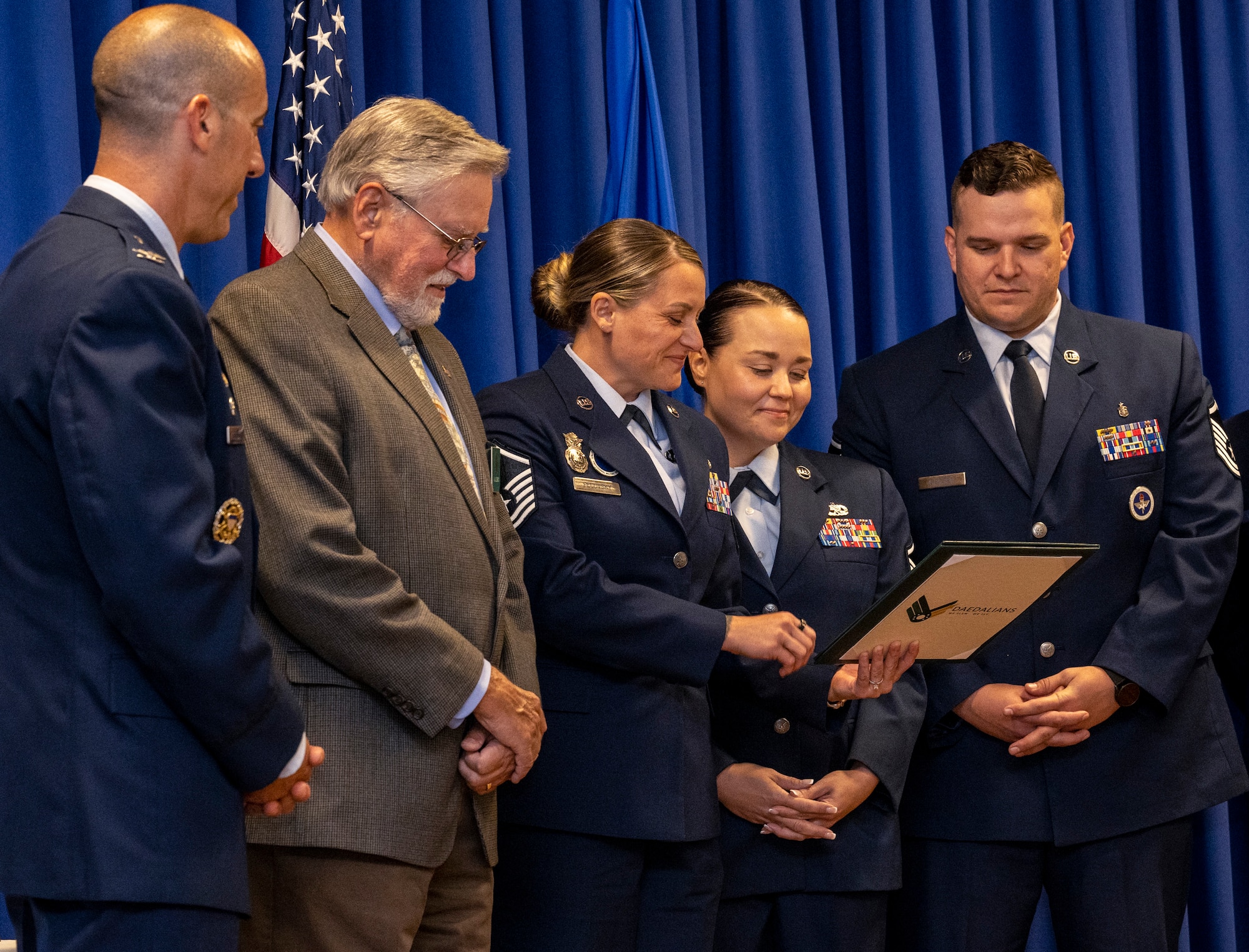 Airmen from the Thomas N. Barnes Center for Enlisted Education's Foundations Force Development Section read the citations that accompanied the 2024 General Muir S. Fairchild Educational Achievement Award during an award ceremony on Maxwell Air Force Base, Alabama, June 11, 2025. (U.S. Air Force photo by Brian Ferguson)