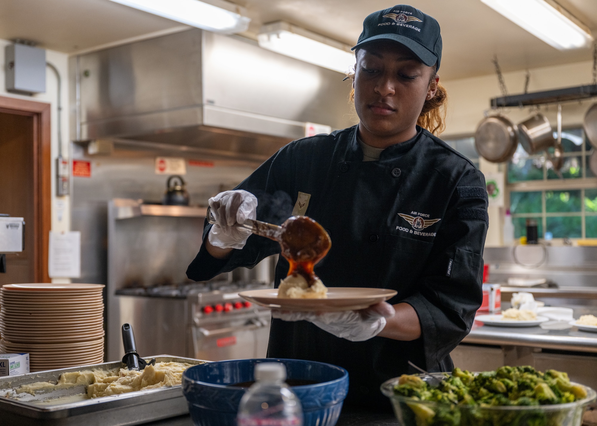 Airman prepares plate of food