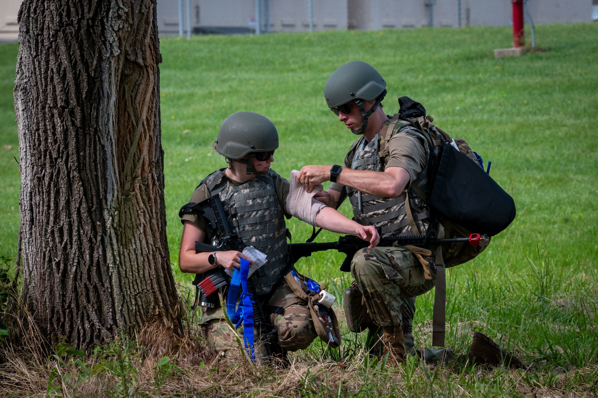 a person renders aid to a simulated casualty
