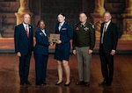 Air Force Brig. Gen. Gwendolyn Foster, 59th Medical Wing commander, presents Air Force Capt. Mikalyn DeFoor, Orthopaedic Surgery resident, the Maj. David Berry Award during the San Antonio Uniformed Services Health Education Consortium graduation ceremony at the Scottish Rite Auditorium, downtown San Antonio, June 6, 2025. This award is presented to the graduating SAUSHEC resident who best exemplifies the spirit and character of Maj. Dave Berry, which include superb professional competence; outstanding collegial relations as a teacher, mentor and consultant and an exemplary ability to balance personal and professional life. (DOD Photo by James Camillocci)