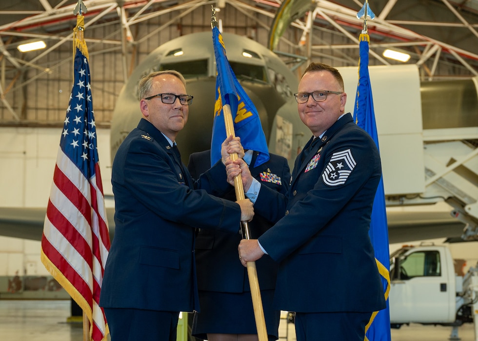 man holds flag to man