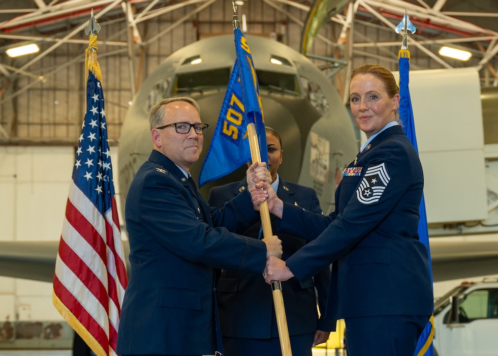 man hands flag to woman