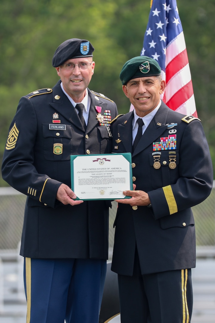 From left, Command Sgt. Maj. William Ferland, outgoing State Command Sergeant Major, New Hampshire National Guard, and Maj. Gen. David Mikolaities, Adjutant General for the NHNG, pose with the Legion of Merit certificate during his retirement ceremony, June 8, 2025, at the Edward Cross Training Complex, Pembroke, N.H.