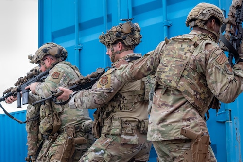 a fire team prepares to enter a structure