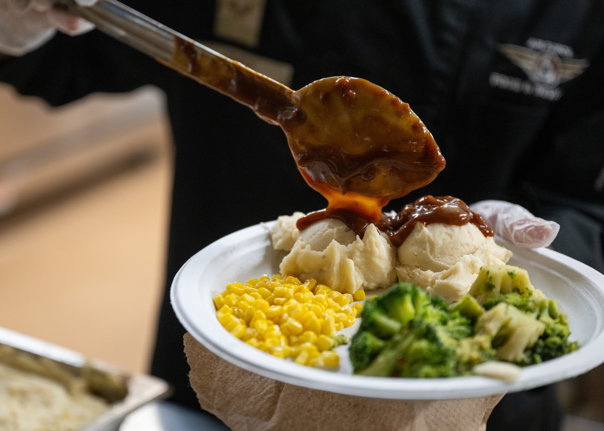 Airman prepares plate of food