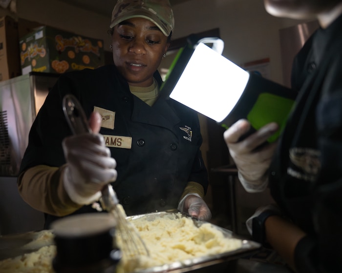 Airmen prepare food