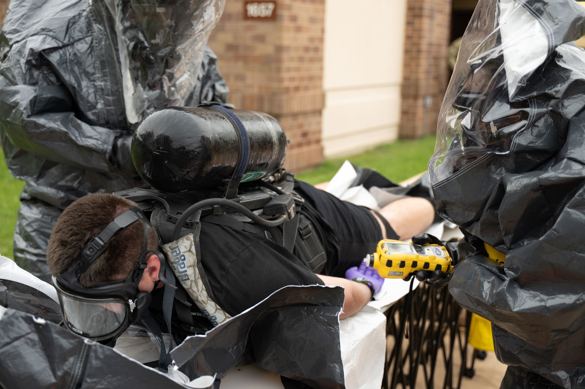 The 33rd Weapons of Mass Destruction Civil Support Team Survey Section simulate emergency doffing during a full-scale chemical, biological, radiological, nuclear and explosive exercise at Joint Base Andrews, Md., May 21, 2025.