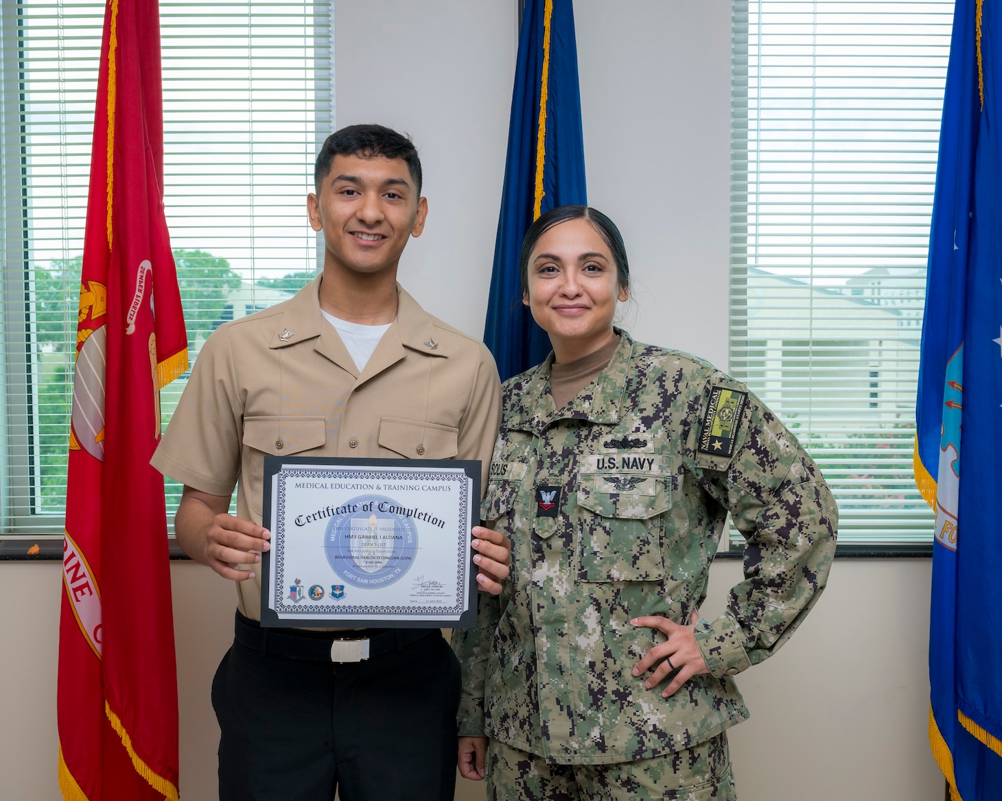 Hospital Corpsman 3rd Class Gabriel Aldana and Hospital Corpsman 2nd Class Rafie Solis pose for a picture after Aldana's graduation from the Navy Medicine Training Support Command's Behavioral Health Technician Course (BHT) at Joint Base San Antonio-Fort Sam Houston, Texas, June 11, 2025. BHT is a consolidated program that brings together students from the Army, Navy, Air Force, Coast Guard and Marine Corps, and focuses on a broad base of subjects such as human growth and development, theories of counseling, group therapy, mental health assessments, mental illness diagnosis and treatment, psychopharmacology, management of aggressive behavior, psychological testing, and combat operational stress control. (U.S. Navy photo by Malcolm McClendon)