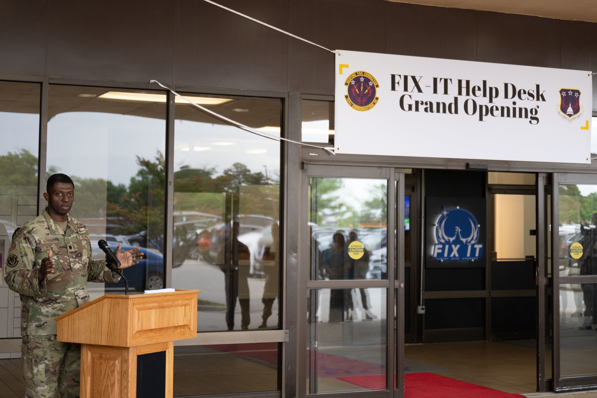 U.S. Air Force Lt. Col. James Nicholson, commander of the 744th Communications Squadron, speaks at the Fix IT Help Desk Grand Opening at Joint Base Andrews, Md., May 27, 2025. The walk-up help desk opened to provide on-demand assistance for client systems, ensuring that personnel have the tools they need for mission success. (U.S. Air Force photo by Airman 1st Class Patrick Njuguna)