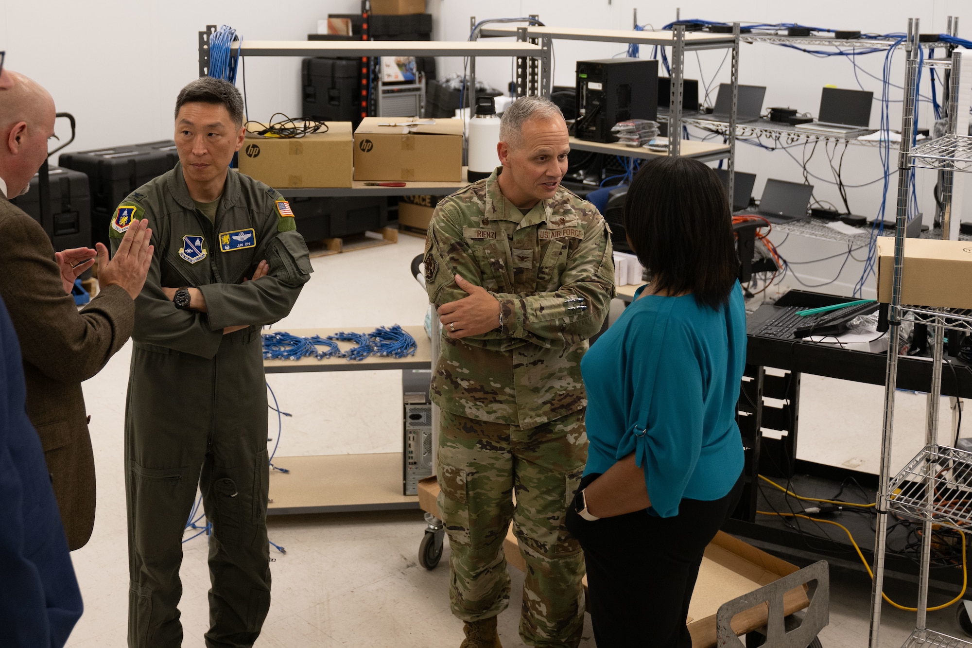 U.S. Air Force Col. Jun Oh, left, 316th Wing and installation commander, and Col. Patrick Rienzi, 844th Communications Group commander, learn the process of the Non-Secure Internet Protocol Router imaging room during a tour of the Fix IT Walk-Up Help Desk building at Joint Base Andrews, Md., May 27, 2025. The walk-up help desk opened to house smart lockers, peripheral vending machines, an in-person help desk, a Secure Internet Protocol Router cafe, a Local Registration Authority station, along with many other functions. (U.S. Air Force photo by Airman 1st Class Patrick Njuguna)