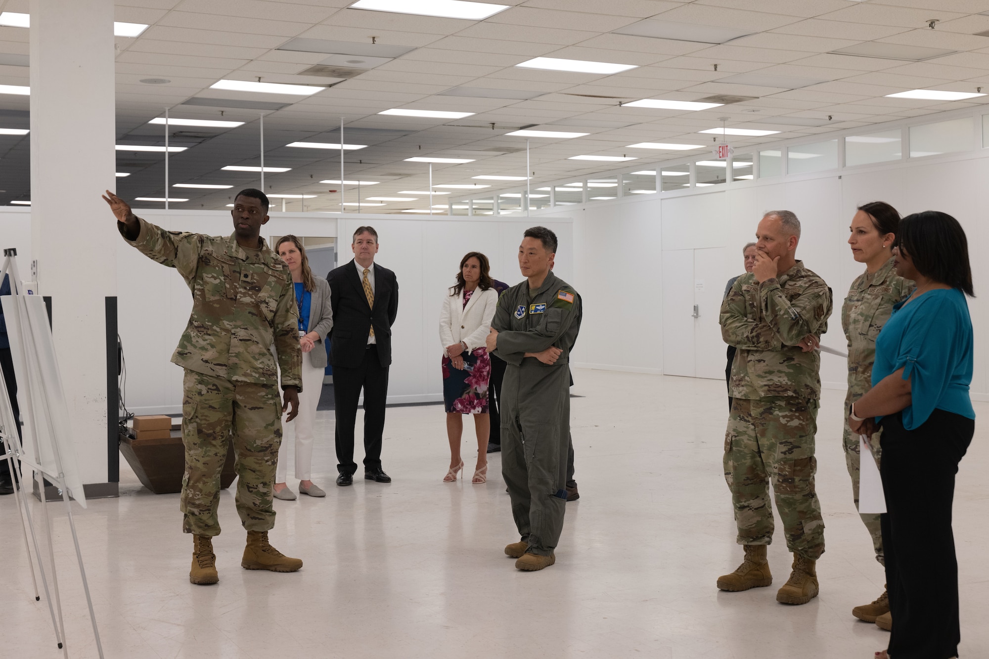 U.S. Air Force Lt. Col. James Nicholson, left, commander of the 744th Communications Squadron, briefs base leadership on future plans for the new space during the Fix IT Help Desk Grand Opening tour at Joint Base Andrews, Md., May 27, 2025. The walk-up help desk also serves as an IT warehouse for the entire National Capital Region, with plans to set up spaces for meetings, training and conferences. (U.S. Air Force photo by Airman 1st Class Patrick Njuguna)
