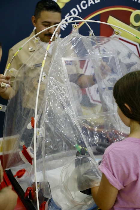 TAKOMA, Md. (June 09, 2025) Hospital Corpsman 2nd class Gilberto Arechigaguzman, with Naval Medical Research Command (NMRC), engages with students at Piney Branch Elementary School about work done by and career opportunities in the Navy and in Medical Research. Piney Branch students had the opportunity to speak with active-duty Sailors and command scientists during the event. NMRC, headquarters of NMR&D, is engaged in a broad spectrum of activity from basic science in the laboratory to field studies in austere and remote areas of the world to investigations in operational environments. In support of Navy, Marine Corps and joint U.S. warfighter health, readiness and lethality, researchers study infectious diseases, biological warfare detection and defense, combat casualty care, environmental health concerns, aerospace and undersea medicine, operational mission support and epidemiology. For 250 years, Navy Medicine, represented by more than 44,000 highly-trained military and civilian healthcare professionals, has delivered quality healthcare and enduring expeditionary medical support to the warfighter on, below, and above the sea and ashore. (U.S. Navy photo by Elliott Page /Released)