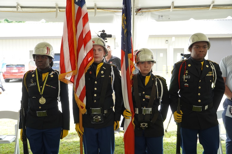 Groves High School Junior Reserve Officer’s Training Corps Color Guard Team presented the colors during a vessel dedication ceremony with the U.S. Army Corps of Engineers, June 12, 2025. Groves High School is Sgt. Tyrone Chisholm’s alma mater. A native of Savannah, Georgia, Chisholm was assigned to the 2nd Squadron, 3rd Armored Cavalry Regiment at Fort Carson, Colorado, when he lost his life Nov. 11, 2005, while conducting combat patrols through the streets of Tal Afar, Iraq, serving as a gunner on an M1A2 Abrams tank in support of the fight against terrorism.