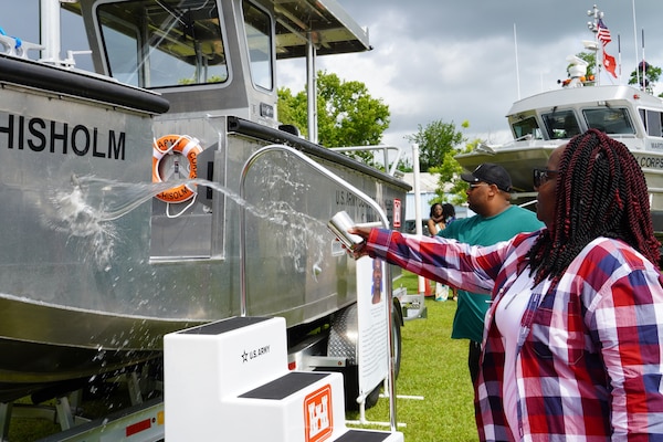 Family members of Sgt. Tyrone Chisholm douse water across the bow of the S/V Chisholm during a dedication ceremony, June 12, 2025, at the U.S. Army Corps of Engineers, Savannah District’s Engineers Depot in Savannah, Georgia.