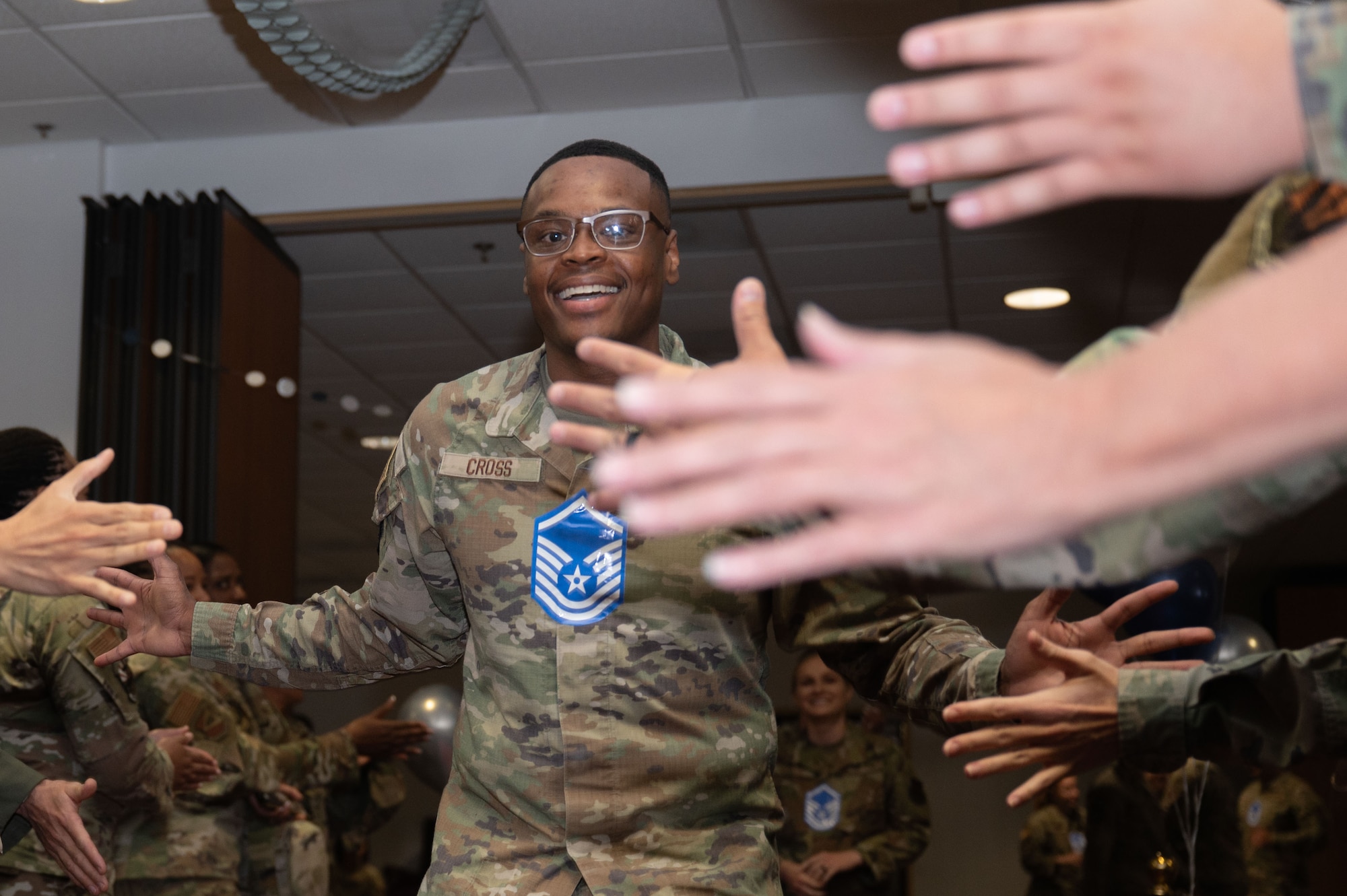 U.S. Air Force Tech. Sgt. Patreiz Cross, 355th Medical Group continuous medical readiness noncommissioned officer in charge, walks down the red carpet during the Master Sergeant Release Party at Davis-Monthan Air Force Base, Arizona, June 11, 2025. The event recognized the achievements of Air Force personnel advancing to the senior enlisted ranks. (U.S. Air Force photo by Airman Jaden Kidd)