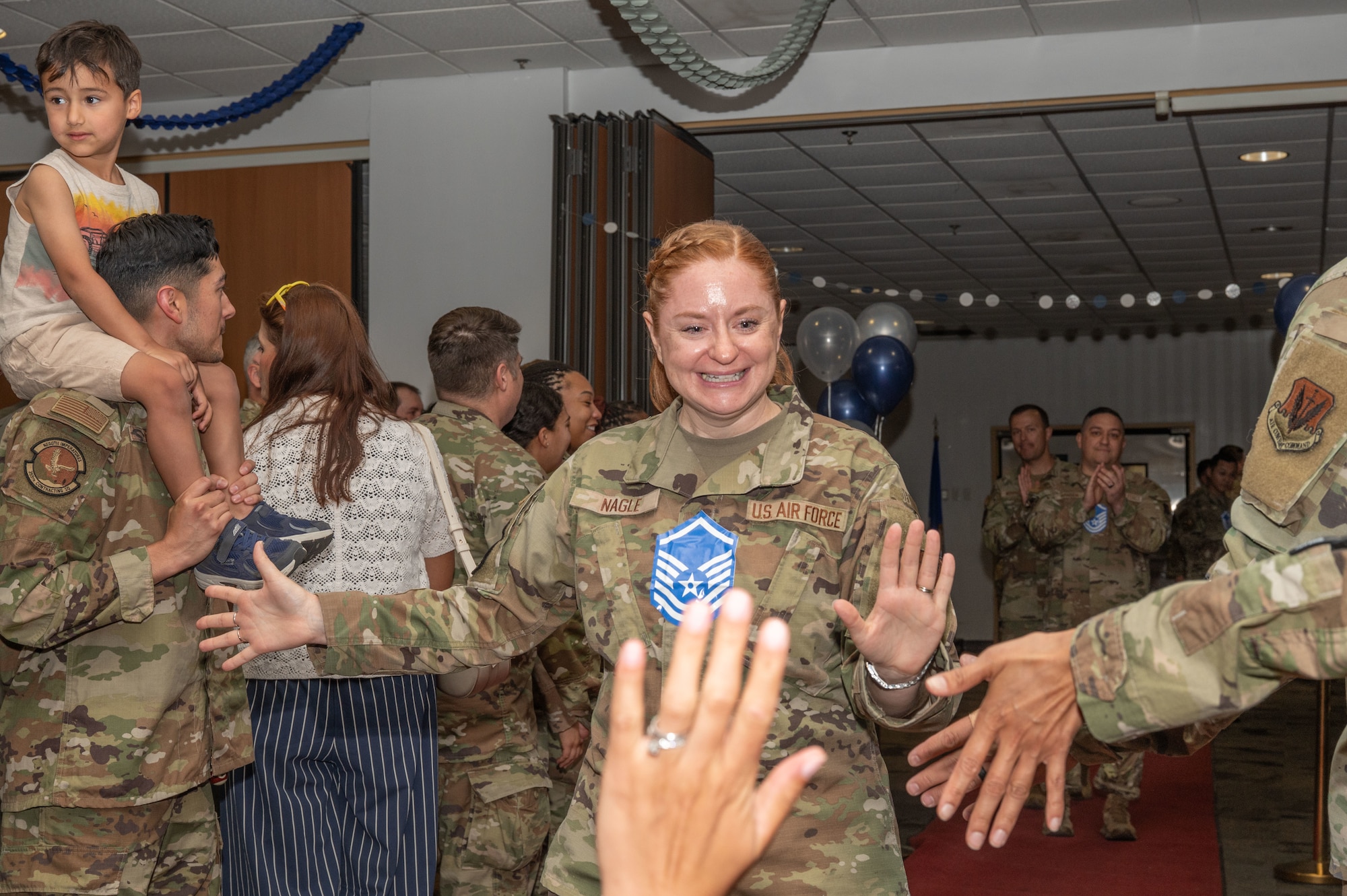 U.S. Air Force Tech. Sgt. Kimberly Nagle, 355th Wing Public Affairs noncommissioned officer in charge, walks down the red carpet during the Master Sergeant Release Party at Davis-Monthan Air Force Base, Arizona, June 11, 2025. The event recognized the achievements of Air Force personnel advancing to the senior enlisted ranks. (U.S. Air Force photo by Airman Jaden Kidd)