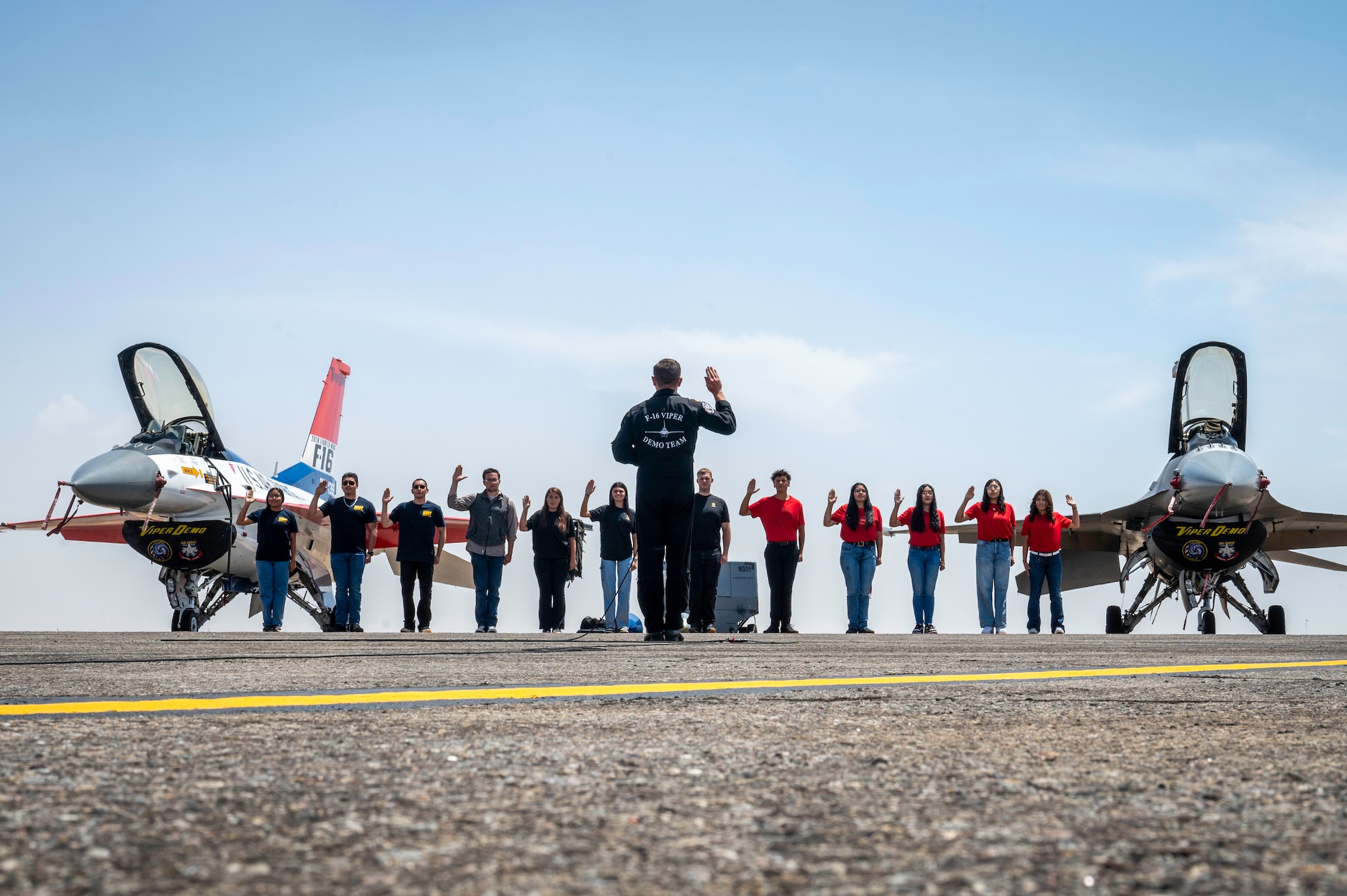 Twelve members perform swear in ceremony in front of two F16's
