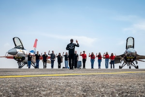 Twelve members perform swear in ceremony in front of two F16's