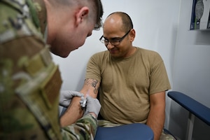 Man in uniform gets blood drawn