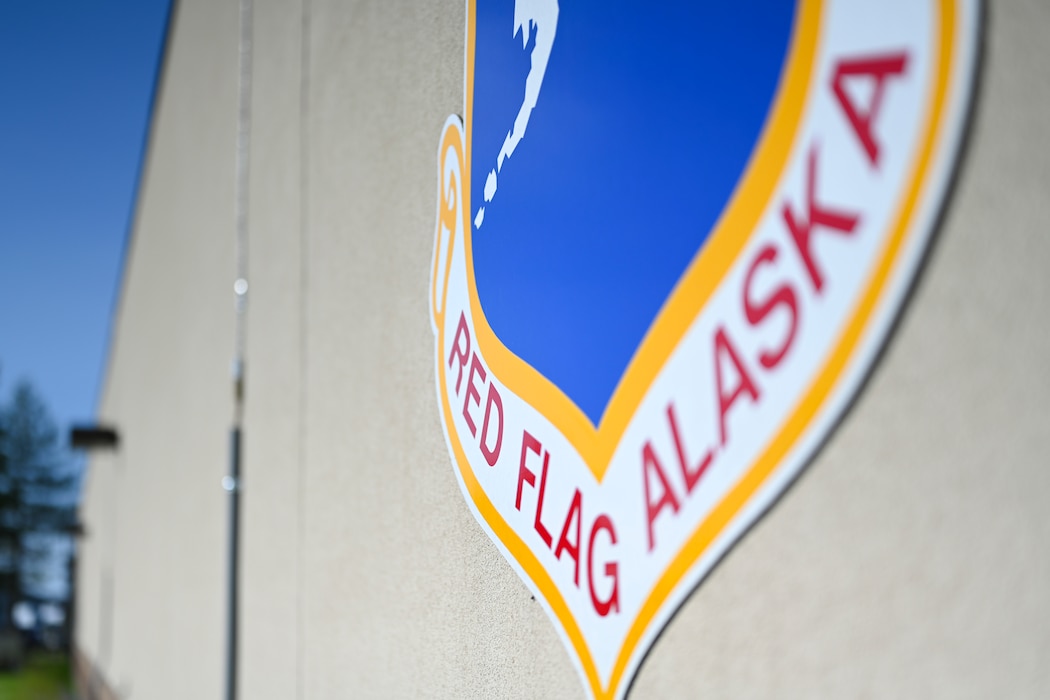 A Red Flag-Alaska crest is displayed outside the 353rd Combat Training Squadron building at Eielson Air Force Base, Alaska, June 12, 2025.