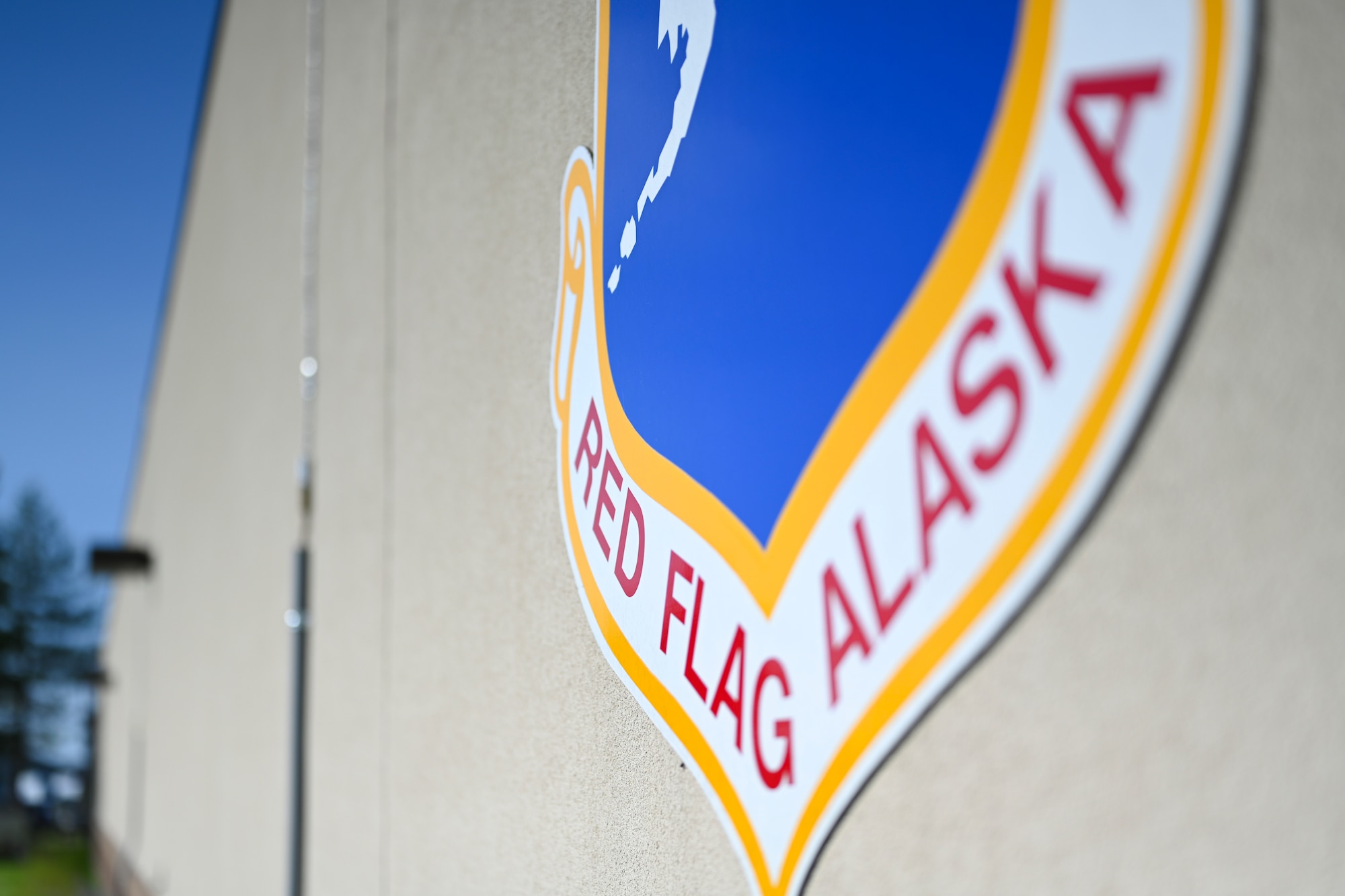 A Red Flag-Alaska crest is displayed outside the 353rd Combat Training Squadron building at Eielson Air Force Base, Alaska, June 12, 2025.