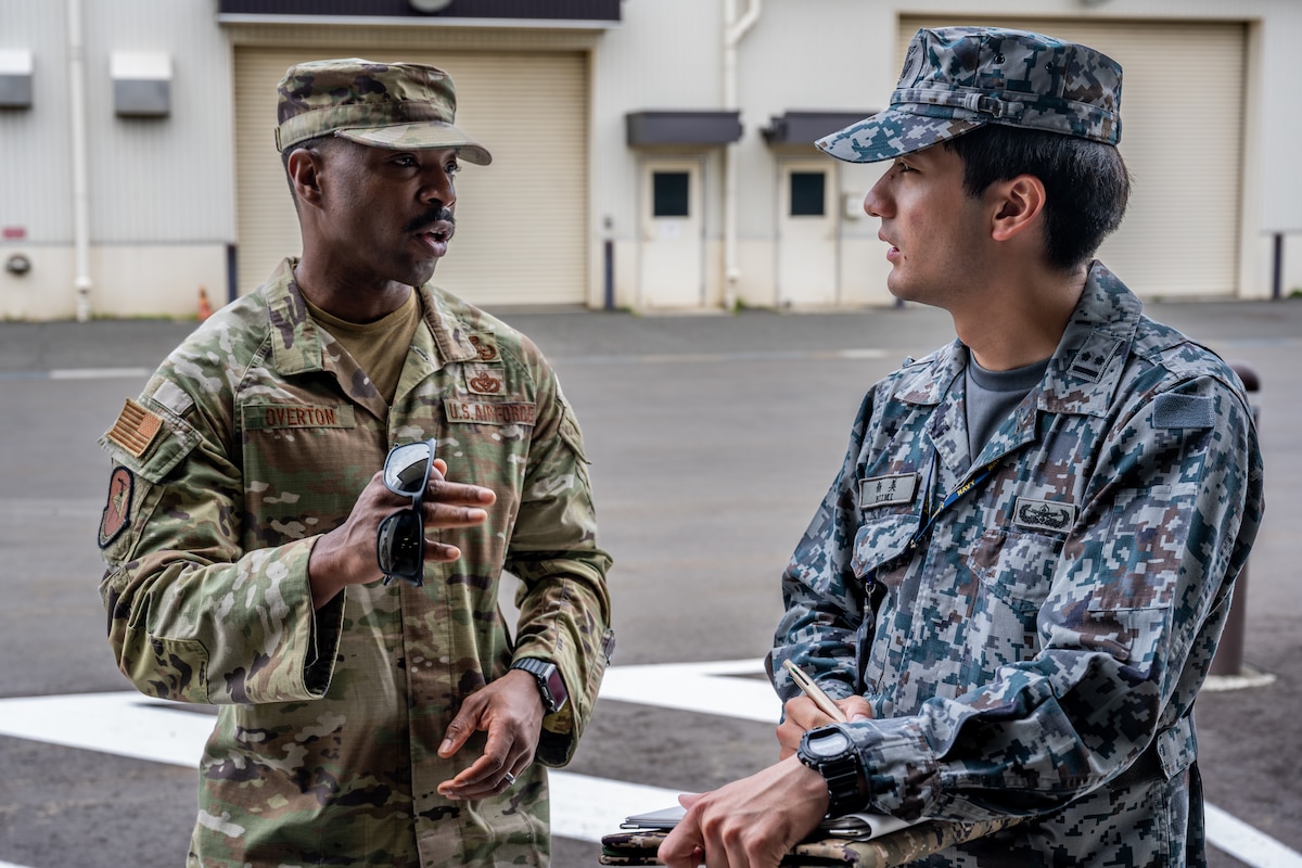 U.S. Air Force Senior Master Sgt. Michael Overton, 35th Civil Engineer Squadron explosive ordnance disposal (EOD) team superintendent, discusses EOD training with Japan Air Self-Defense Force (JASDF) 1st Lt. Yuta Niimi, 4th Depot Maintenance Supply Division EOD technician, at Misawa Air Base, Japan, June 12, 2025.