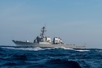 Arleigh Burke-class guided missile destroyer USS Cole (DDG-67) moors off the coast of Charleston, South Carolina, April 15, 2025 during Exercise Southern Lightning. For the exercise, Naval Information Warfare Center Atlantic tested several pieces of equipment as part of their routine scientific mission to enhance the interoperability and performance of various naval communications system configurations and capabilities. (U.S. Air Force photo by Staff Sgt. Emily Farnsworth) [Stock Photo]