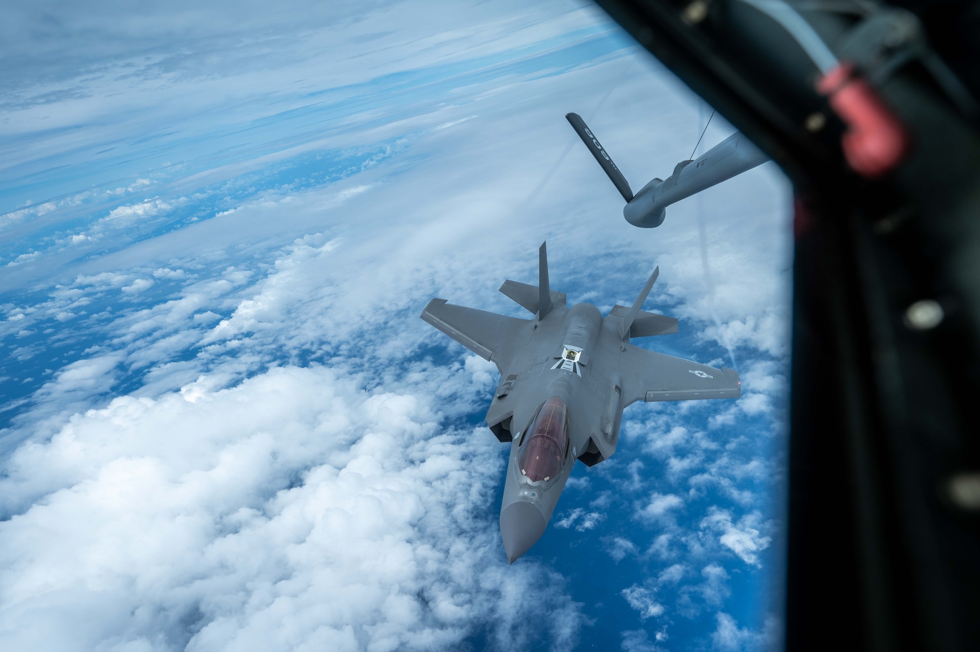 A F-35A Lightning ll aircraft approaches another aircraft for refueling