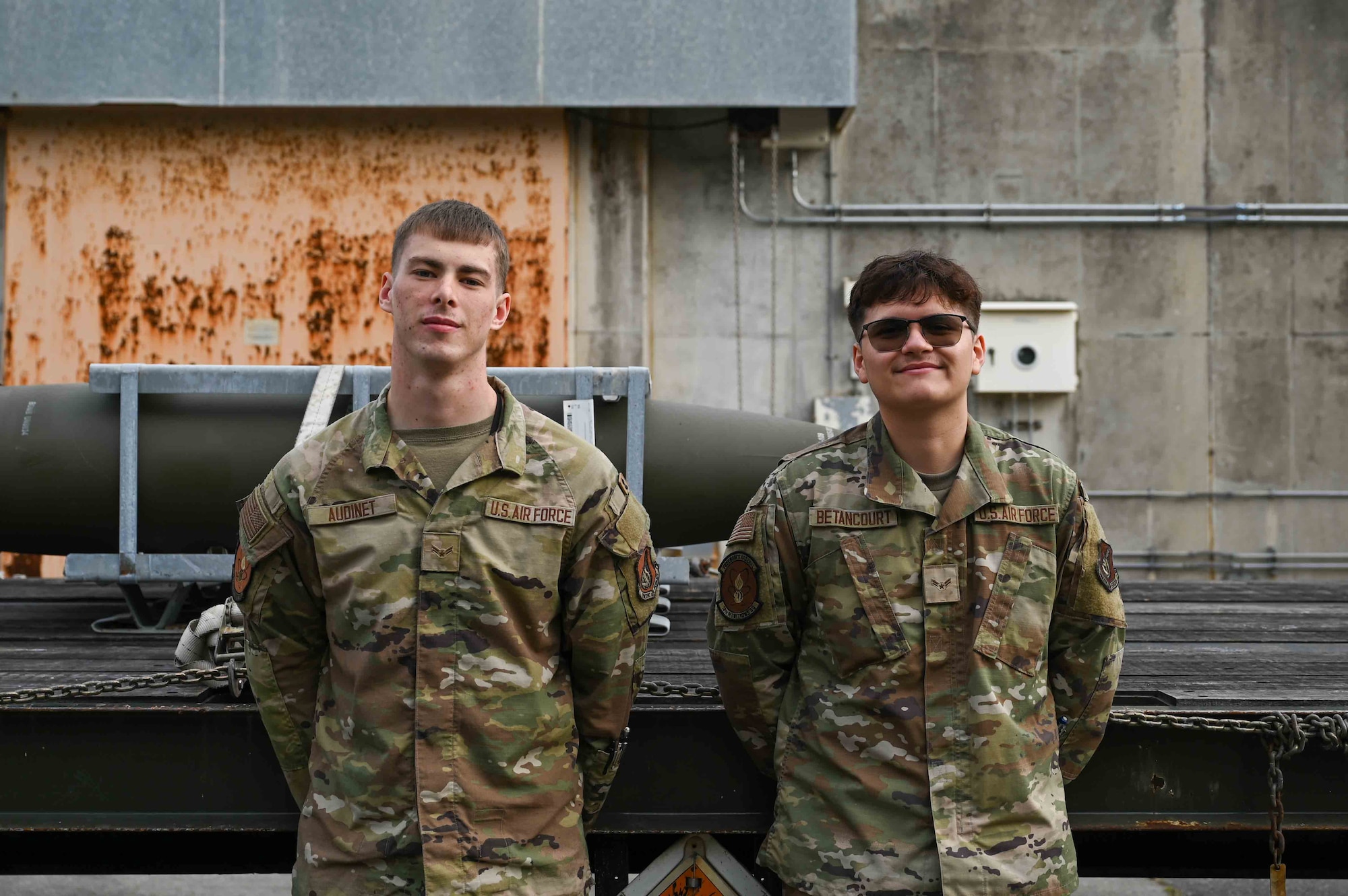 Two U.S. Air Force Airmen pose for a photo.