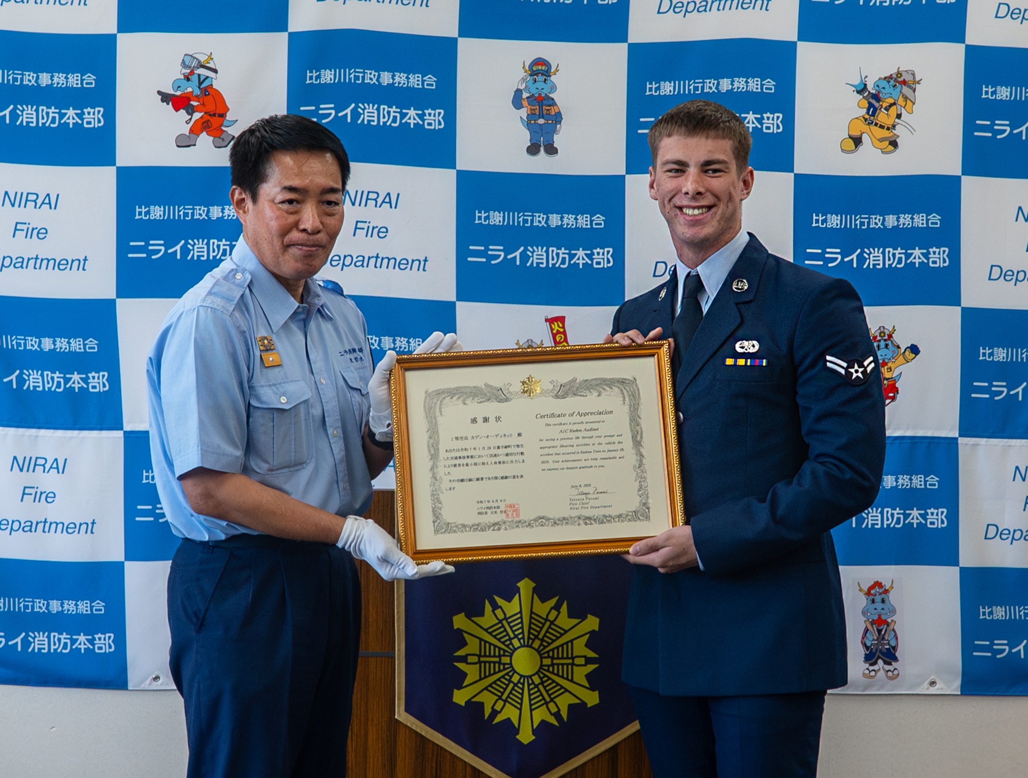 A U.S. Air Force Airman poses for a photo with a certificate of appreciation.